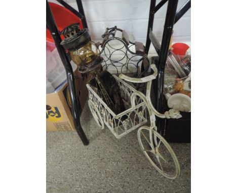 A metal wine rack, garden plant holder and garden lamp