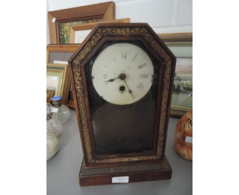 A 19th century enamel faced mantle clock in decorative wood frame
