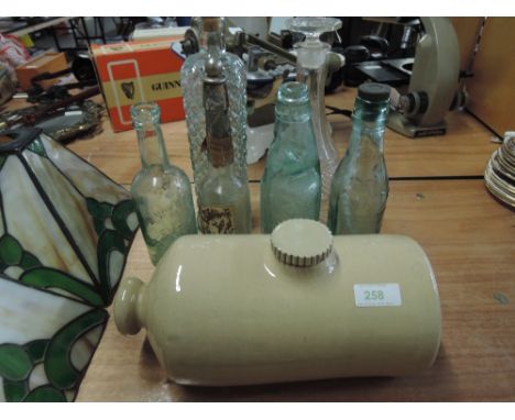 A selection of vintage bottles including MW Hodgson, Outgate near Ambleside and Batey of Brampton and ceramic bed warmer