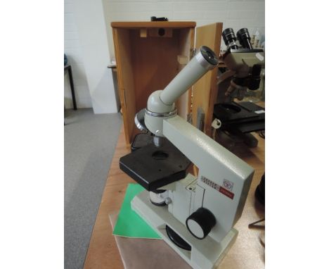 A Nomo Russian microscope boxed with Olympus and Reichert lenses and box of various parts and lenses