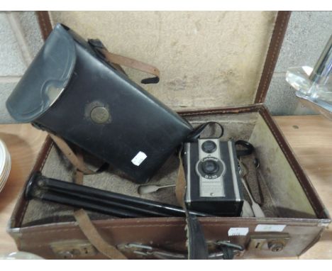 A vintage suitcase containing a 3A Autographic Kodak Junior in case with user manual, a Coronet D-20 camera, camera stand and