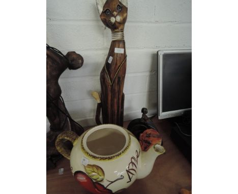 A miscellaneous collection including treen clock, ornamental cat and a plant pot in the form of an oversized teapot