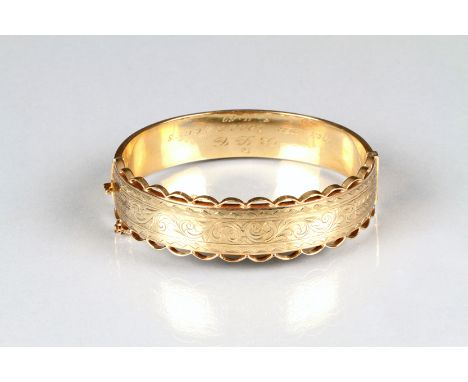 Boxed Victorian ladies 9 carat gold stiff bangle with engraved scroll work decoration, total weight 27 grams 