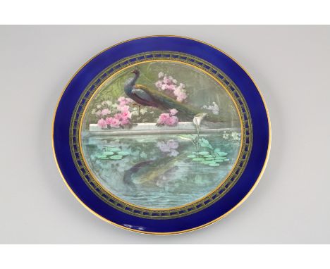 Royal Worcester charger, hand painted with a peacock standing by a pond, monogrammed by Jarman, date coded 1908. 30cm diamete