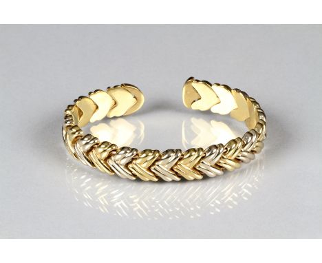 Ladies 9K yellow and white gold stiff bangle, weight 21.2 grams 