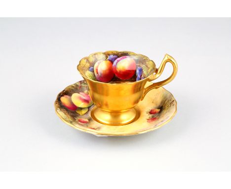 Royal Worcester scallop rimmed cup and saucer, hand painted with fruit in naturalistic background, signed Austin, cup with gi