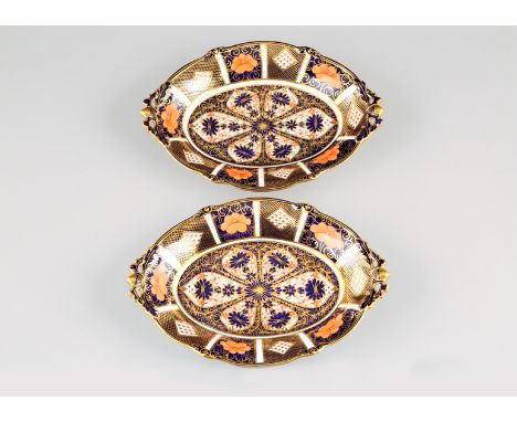 Pair Royal Crown Derby cake plates, oval form, with elongated and pierced ends with acorn finials, raised on pierced bracket 