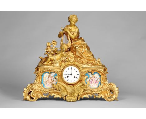 19th Century French ormolu mantel clock, the central dial flanked either side by hand painted Sevres style ceramic plaques, d