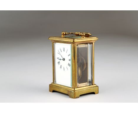French brass carriage clock, enamel dial, Roman numerals with leather travelling case. 11cm high (excluding folding handle) 