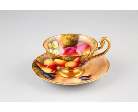 Royal Worcester tea cup and saucer, hand painted with fruit in a naturalistic background, signed Townsend, date coded 1934. D