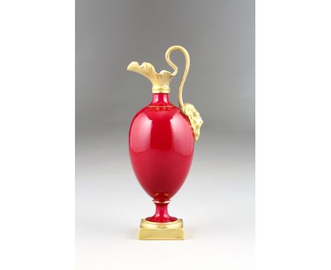 Royal Worcester ewer, ovoid form raised on a gilt square foot, Ruby red 'patent metallic' with gilt handle and Bacchus mask, 