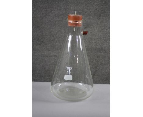 A large Pyrex scientific conical flask with bung.
H.43 Diam. 22 cm. 