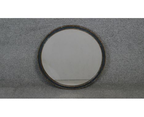 An early 20th century giltwood circular mirror with hanging chain. Diam.46 cm 
