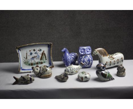 A collection of eleven Tonala Mexican ceramic animals and a plate. Nine pieces by Ken Edwards and two blue and white design a