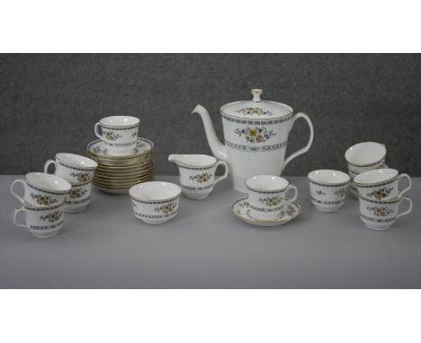 A Minton twelve person part tea service 'Avignon' pattern, comprising eleven cups, twelve saucers, milk jug, sugar bowl and c