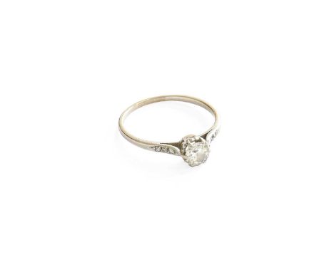 A Diamond Solitaire Ring, the round brilliant cut diamond in a white claw setting, to old cut diamond set shoulders, on a pla