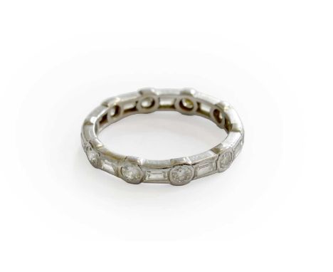 A Diamond Eternity Ring, round brilliant cut diamonds spaced by baguette cut diamonds in white rubbed over settings, finger s