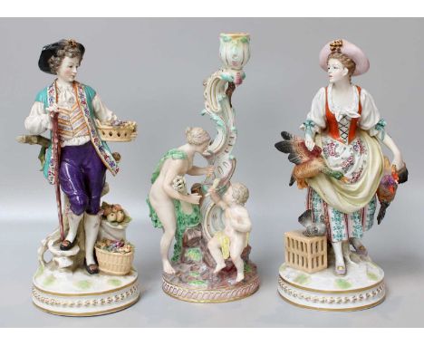 A Pair of Naples Porcelain Figures, early 20th century, in the form of boy selling apples and girl with wildfowl, on circular