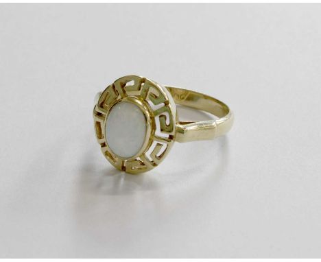 An Opal Ring, the oval cabochon opal in a yellow rubbed over setting, within a Greek key border, to a tapered shoulder plain 