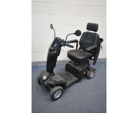 A KOMFY 4 MOBILITY SCOOTER, in a black finish, complete with key, charger, manual, and sales receipt dated July 2021 (conditi