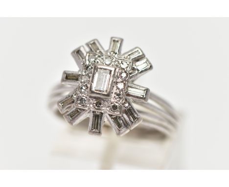 A WHITE METAL DIAMOND CLUSTER RING, raised cluster centring on a rectangular cut diamond in a collet setting, to a single cut