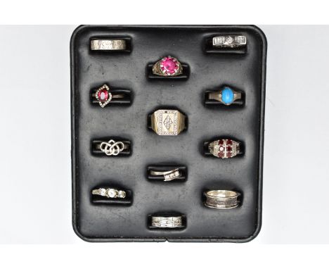 A SELECTION OF SILVER AND MAINLY WHITE METAL RINGS, sitting on a ring pad comprising twelve rings, to include a silver tapere