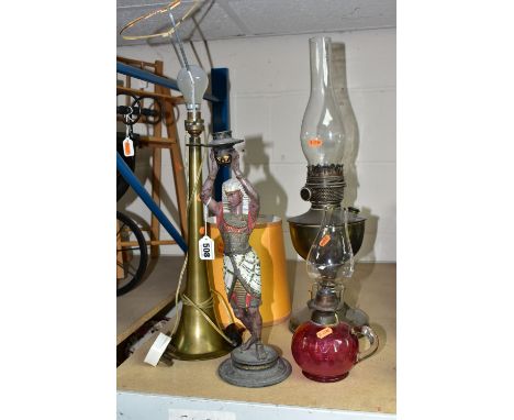 A GROUP OF FOUR LAMPS, comprising a brass oil lamp, height 56cm to top of glass chimney (no shade), a small oil lamp with a c