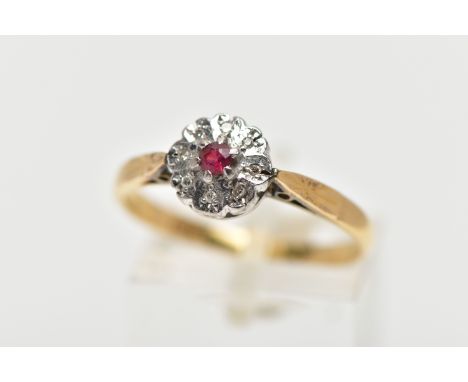 A YELLOW METAL DIAMOND AND RUBY CLUSTER RING, flower design, centring on a circular cut glass filled ruby, within a surround 