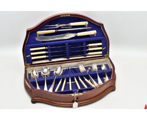A WOODEN CANTEEN, curved wooden canteen complete with a six person table setting of stainless steel cutlery, the knives and c