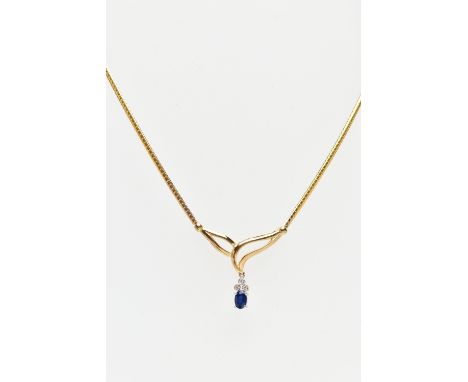 A 9CT YELLOW GOLD, SAPPHIRE AND DIAMOND NECKLACE, V-shape openwork pendant suspending a four claw set, oval cut blue sapphire