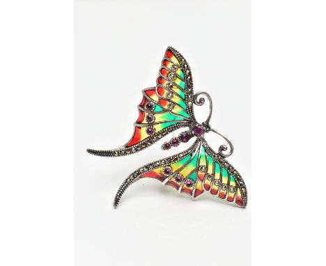 A WHITE METAL PLIQUE A JOUR GEM SET BUTTERFLY BROOCH, the ruby cabochon body, with circular cut ruby head, marcasite highligh