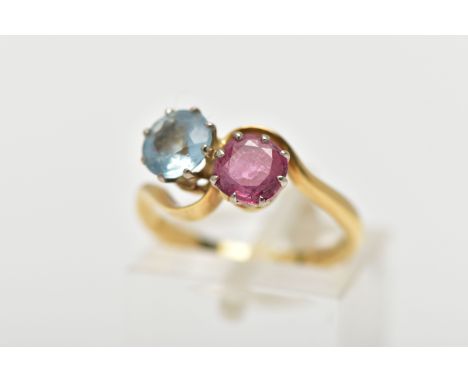 AN 18CT GOLD DRESS RING, a circular cut aquamarine and circular cut glass filled ruby, approximate dimensions 6mm, prong set 