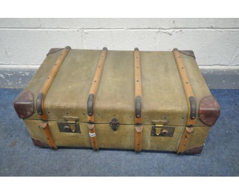 A VINTAGE CANVAS TRAVELLING TRUNK, 78cm x depth 49cm x height 33cm and a distressed domed top trunk, with an internal tray (2