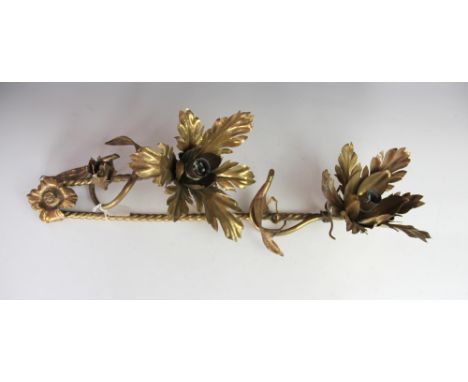 An Arts and Crafts brass wall light, in the manner of W. A. S Benson, with two flower head light fittings, lacking wall mount