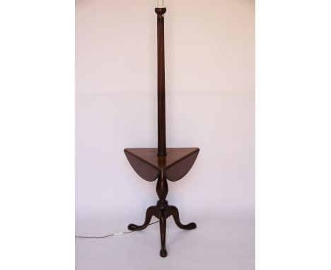 An early 20th century mahogany standard lamp with fluted column and a trifold table to centre and tripod base, 150cm