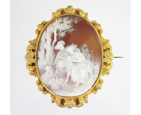 A signed carved shell cameo brooch, early 19th century, the oval brooch carved depicting a shepherd and shepherdess in a wood