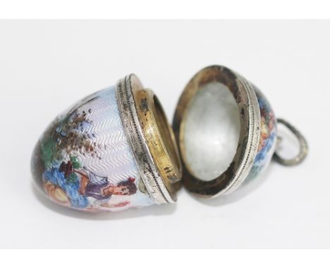 A Continental enamel and white metal mounted egg shaped pendant, probably originally a vinaigrette, 19th century, painted wit