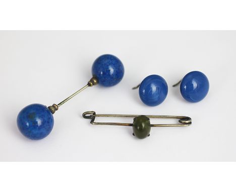 A lapis lazuli set cloak pin, designed as two carved lapis spheres joined by a pin, 6cm long, along with a pair of earrings a