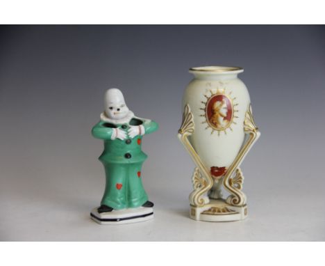 An English porcelain vase, of Worcester type, the egg shaped body raised on tripartite base, decorated with portrait cameos a