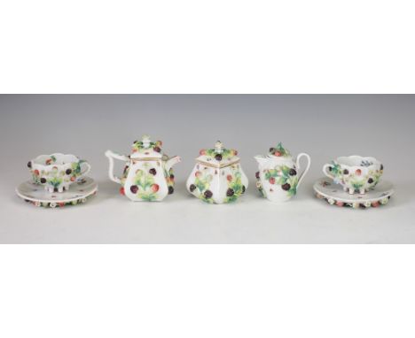 A German porcelain tea service, late 19th/early 20th century, each piece heavily florally and fruit encrusted and decorated i