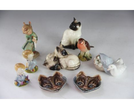 A collection of ceramics, to include; Wade 'Blynken' and 'I've a bear behind', a pair of cat face dishes, a Beswick Robin and