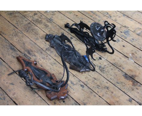 A near pair of Art Nouveau style wrought iron light fittings, one with wood back plate, and a similar twin light wrought iron
