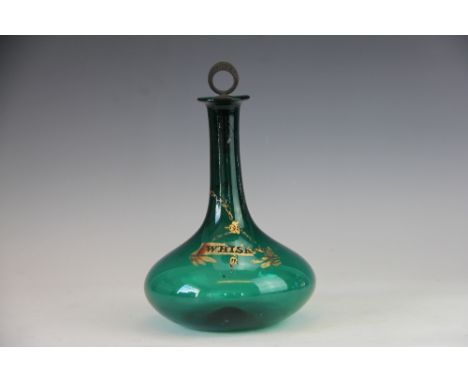 A George III green glass onion shaped decanter and stopper, with gilt 'whisky' detail, with pewter ring stopper also titled, 