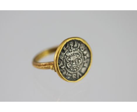 An interesting coin set ring, the yellow metal surround made from a coin, and inset with a Henry III (1216 -1272) Long Cross 