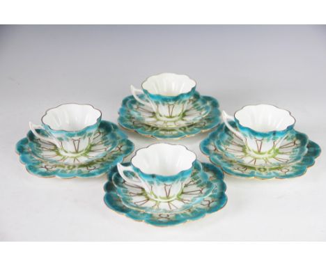 A set of four Foley China Wileman Shelley trios, each of lobed form and decorated with Art Nouveau sinuous flowers in turquoi
