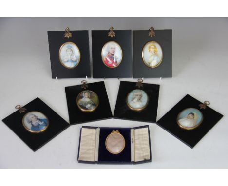 A collection of seven modern ebonised miniature portrait frames, with prints inside, 14.5cm x 12cm, with a brass miniature fr