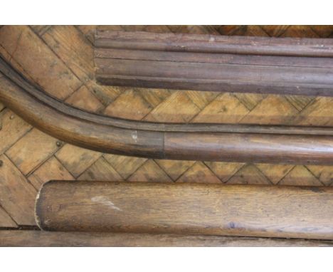 Two large sections of oak country house banister hand rails, largest 216cm, with a section of moulded architectural pine and 