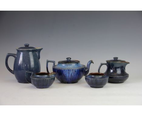 A Bourne Denby three piece tea service, in mottled blue glaze, with a Denby two pint jug and cover and another jug and cover