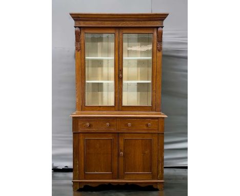 LATE 19TH C. OAK BOOKCASE CABINET, glazed doors enclosing painted interior, two frieze drawers, cupboard base, bracket feet, 