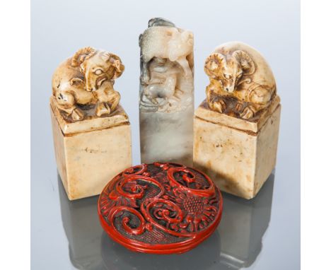 THREE CHINESE HARDSTONE SEALS
each with ram's head finial, along with a lacquer cased red ink block (4) 